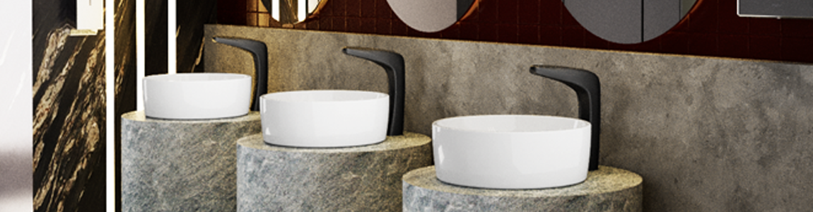 Llave electrónica color negro para lavabo de baño institucional en baño con tonos grises y oscuros